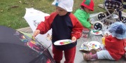 Baby Art: Barn maler på paraply med andre børn i baggrunden
